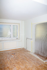 Room renovation. White room repair with dirty floor.