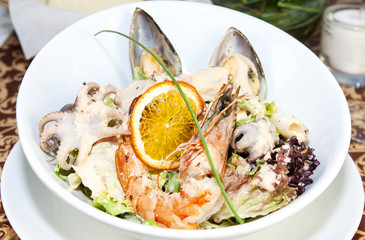 salad with vegetables and seafood on the table in a restaurant