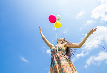 Woman releasing balloons