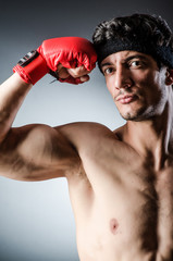 Muscular boxer wiith red gloves