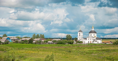 Fototapeta na wymiar Russian summer rural landscape with white church