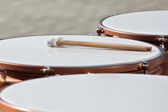Drumsticks lying on timpani