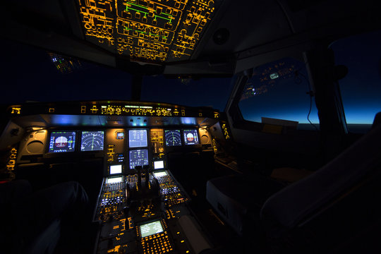 Cockpit of aircraft at sunrise or sunset