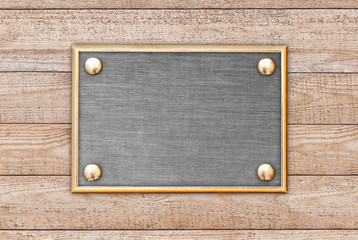 The metal plate on wooden background