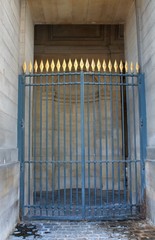Locked blue gate with gold spear tips