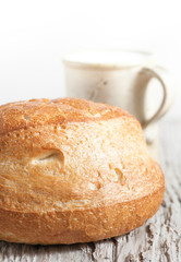 Homemade bread and milk on the wooden board