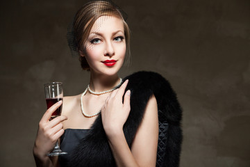 Beautiful woman with glass red wine. Retro style