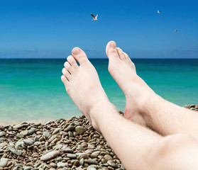 man's legs on the sand beach