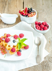 Belgian waffles with whipped cream and fresh berries