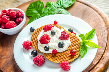 Belgian waffles with whipped cream and fresh berries