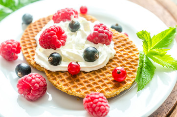Belgian waffles with whipped cream and fresh berries