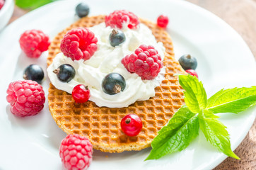Belgian waffles with whipped cream and fresh berries