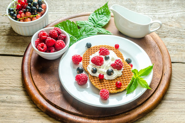 Belgian waffles with whipped cream and fresh berries