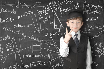 boy near blackboard with formulas