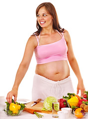 Pregnant woman preparing food .