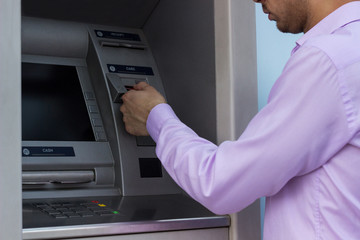 Naklejka na ściany i meble Man using a ATM