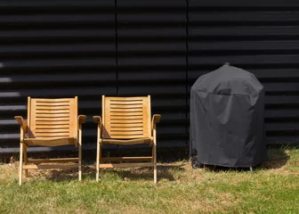 Foto auf Leinwand Two chairs and a covered grill © nielskliim
