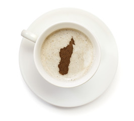 Cup of coffee with foam and powder in the shape of Madagascar.(s