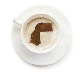 Cup of coffee with foam and powder in the shape of Western Sahar