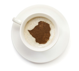 Cup of coffee with foam and powder in the shape of Zimbabwe.(ser
