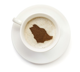 Cup of coffee with foam and powder in the shape of Saudi Arabia.