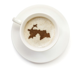 Cup of coffee with foam and powder in the shape of Tajikistan.(s