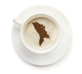 Cup of coffee with foam and powder in the shape of Moldava.(seri