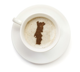 Cup of coffee with foam and powder in the shape of Portugal.(ser