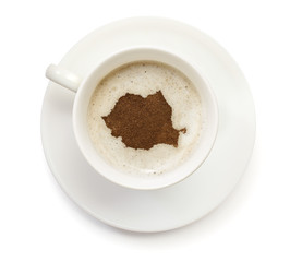 Cup of coffee with foam and powder in the shape of Romania.(seri