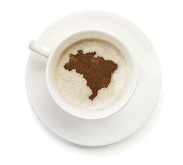 Cup of coffee with foam and powder in the shape of Brazil.(serie