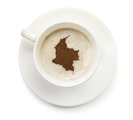 Cup of coffee with foam and powder in the shape of Colombia.(ser