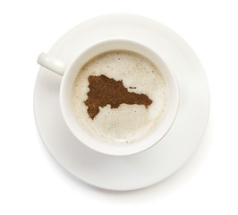 Cup of coffee with foam and powder in the shape of Dominican Rep