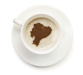 Cup of coffee with foam and powder in the shape of Ecuador.(seri