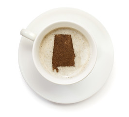 Cup of coffee with foam and powder in the shape of Alabama.(seri