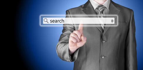Businessman pushing virtual search bar