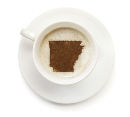 Cup of coffee with foam and powder in the shape of Arkansas.(ser
