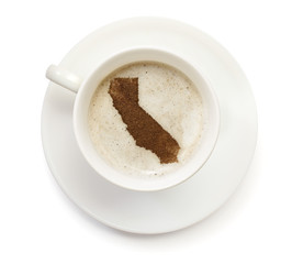 Cup of coffee with foam and powder in the shape of California.(s