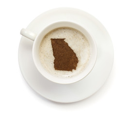Cup of coffee with foam and powder in the shape of Georgia.(seri