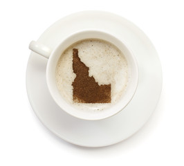 Cup of coffee with foam and powder in the shape of Idaho.(series