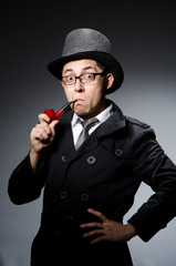 Funny detective with pipe and hat