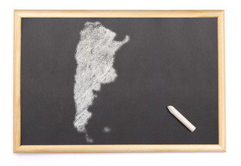 Blackboard with a chalk and the shape of Argentina drawn onto. (