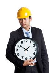 Asian engineer man hold a clock