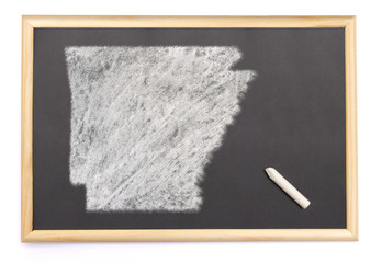 Blackboard with a chalk and the shape of Arkansas drawn onto. (s