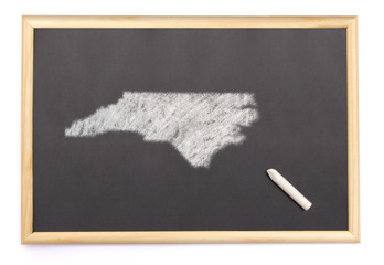 Blackboard with a chalk and the shape of North Carolina drawn on