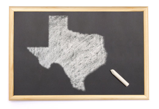 Blackboard with a chalk and the shape of Texas drawn onto. (seri