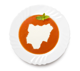 Plate tomato soup with cream in the shape of Nigeria.(series)