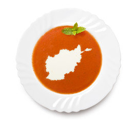 Plate tomato soup with cream in the shape of Afghanistan.(series