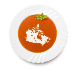 Plate tomato soup with cream in the shape of Canada.(series)