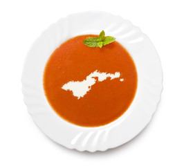 Plate tomato soup with cream in the shape of American Samoa.(ser