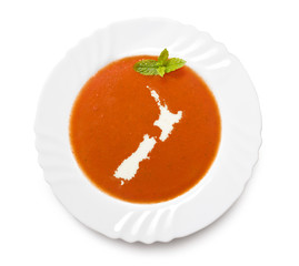 Plate tomato soup with cream in the shape of New Zealand.(series
